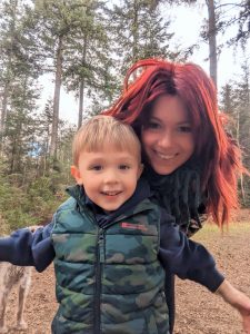 Hayley, single mum with red hair, standing with her young son