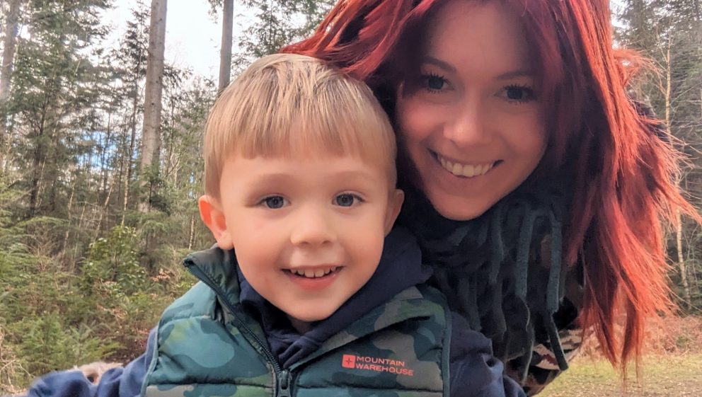 Hayley, single mum with red hair, standing with her young son