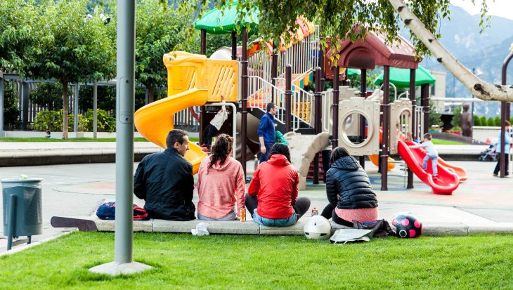 Photo of Parents watching children in a playground