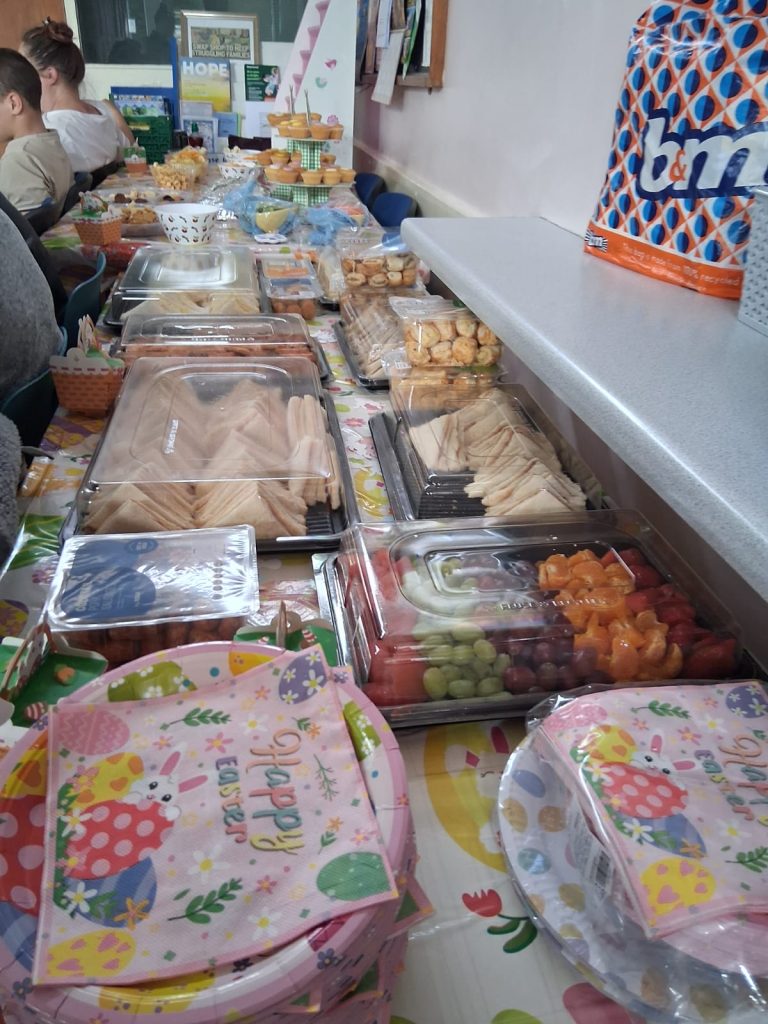 A table full of party food, with Happy Easter themed plates and napkins